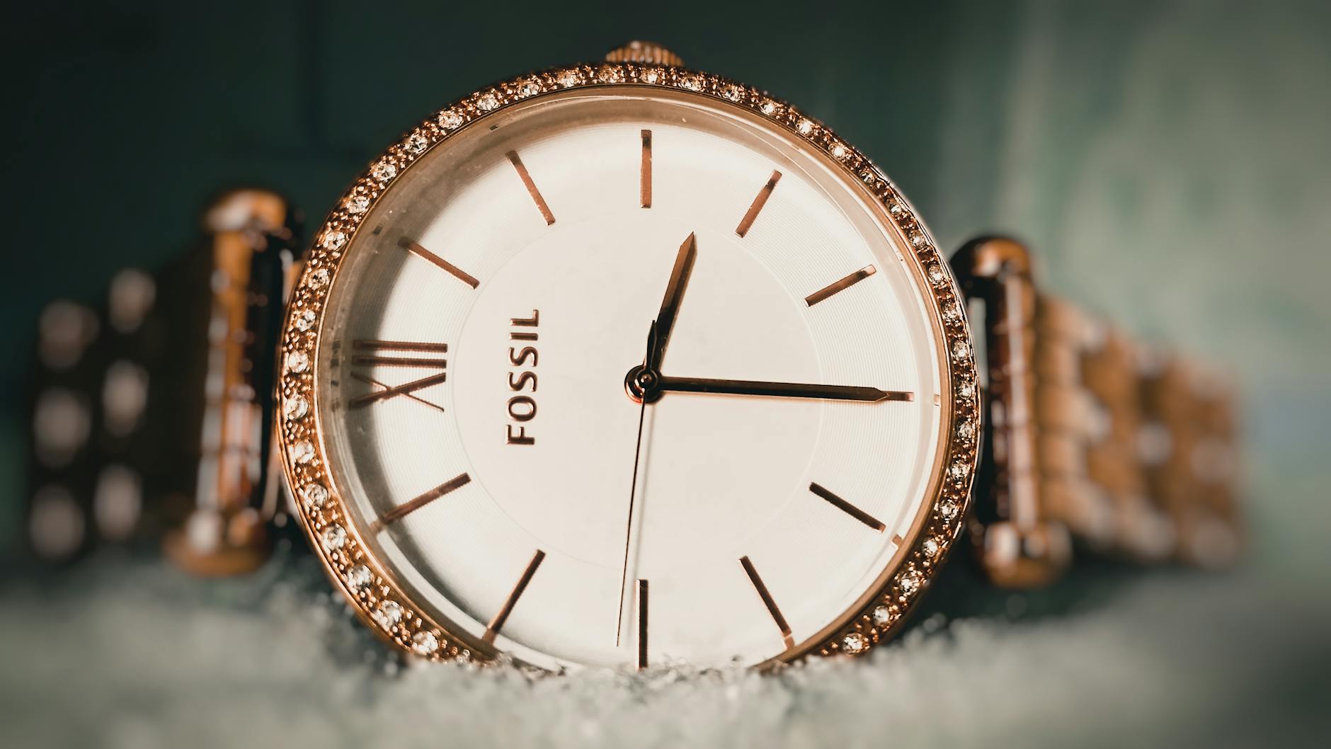 round gold colored fossil analog watch