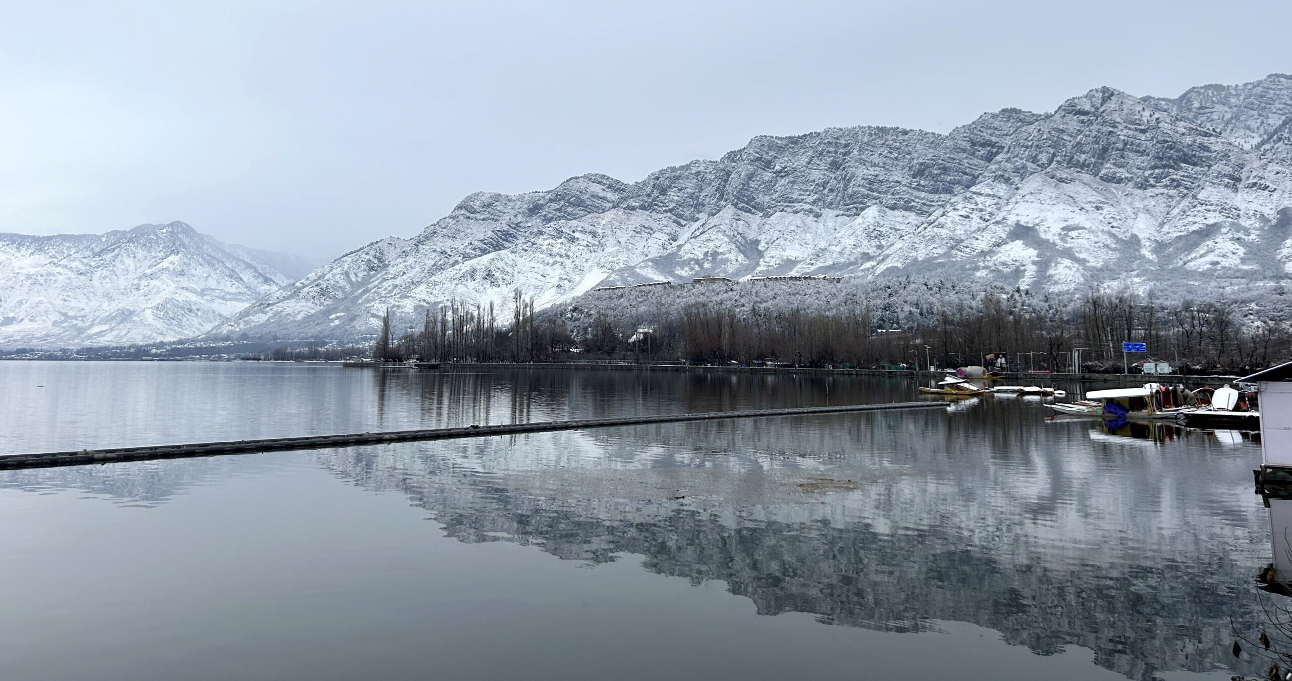 Kashmir Snow covered Shikaras parked in Dal Lake under snow covered Zabarwan mountains after Srinagar receives much awaited seasons first snowfall in Srinagar Umar Ganie 3 scaled 1