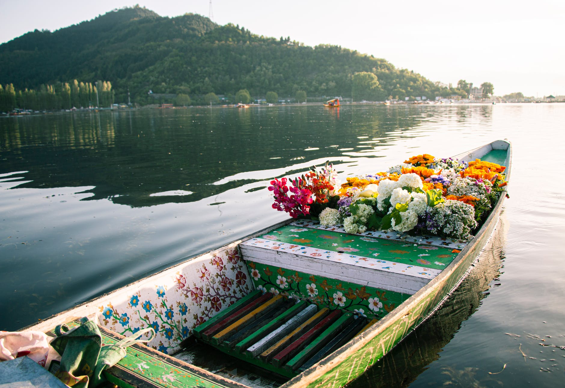a wooden flower boat on dal lake