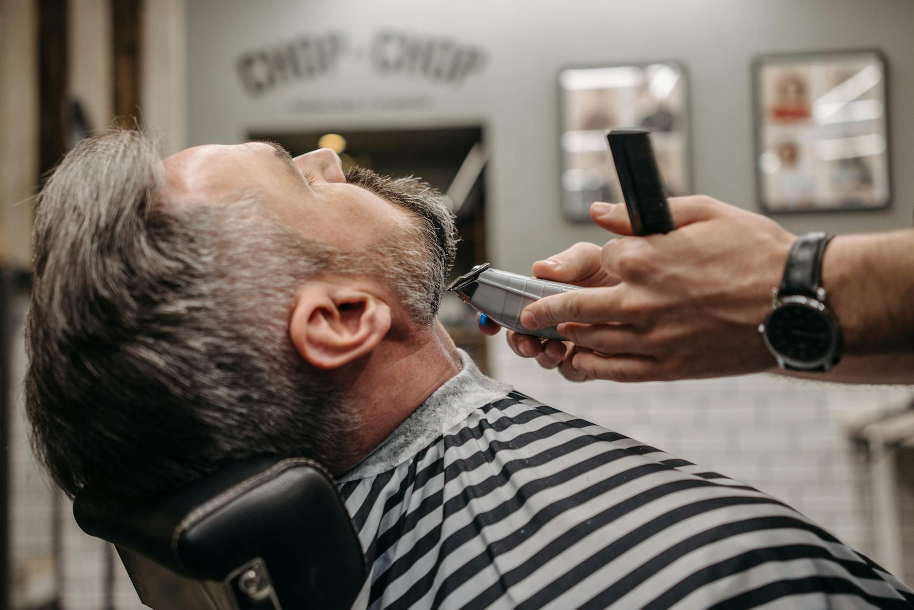 a man having beard trimming